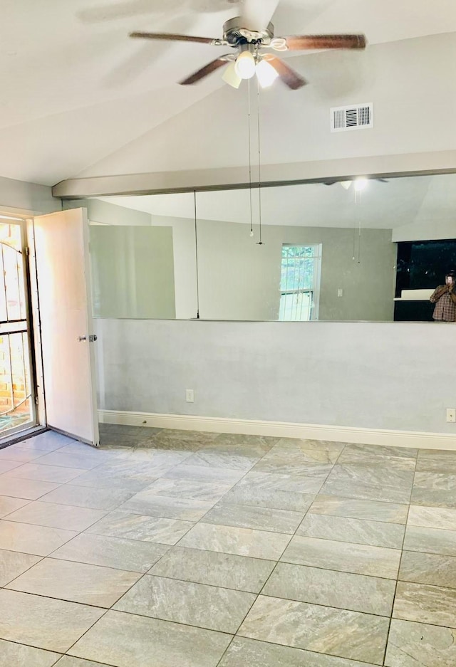 spare room featuring ceiling fan and lofted ceiling