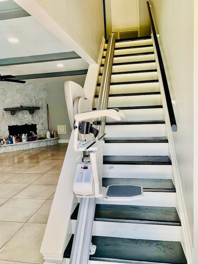 stairs featuring tile patterned floors and ceiling fan