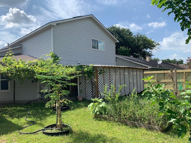 view of side of home featuring a lawn