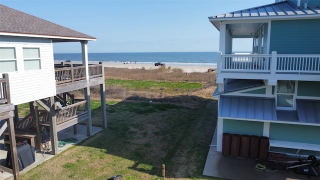 view of yard with a view of the beach and a water view