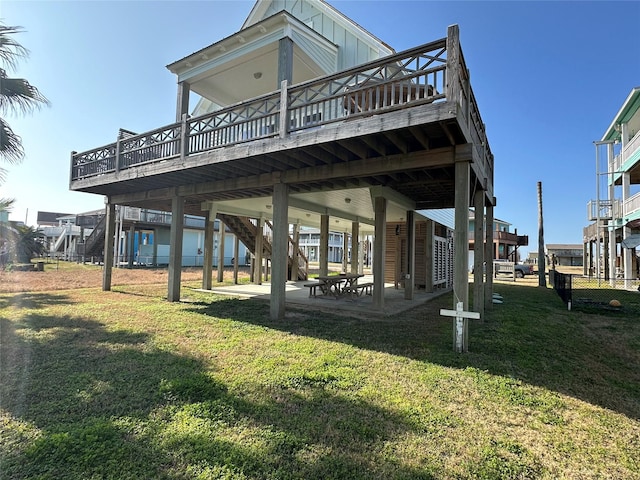 view of home's community with a wooden deck, a patio area, and a lawn