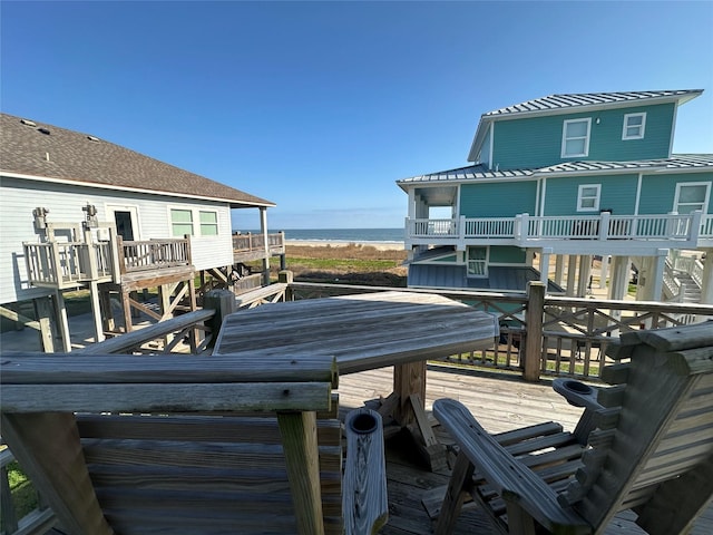 deck with a water view and a beach view