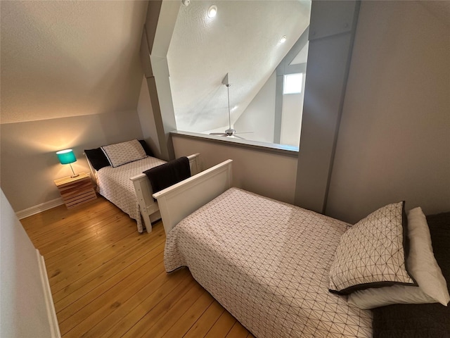 bedroom featuring lofted ceiling and light hardwood / wood-style flooring