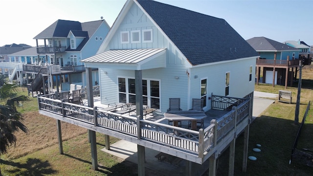 rear view of house featuring a yard