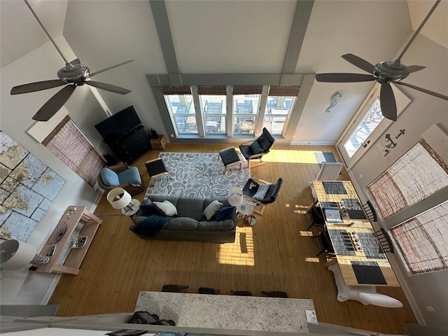 living room featuring ceiling fan, high vaulted ceiling, and a wealth of natural light