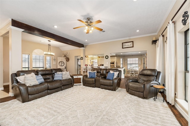 living room with crown molding, hardwood / wood-style floors, and ceiling fan with notable chandelier