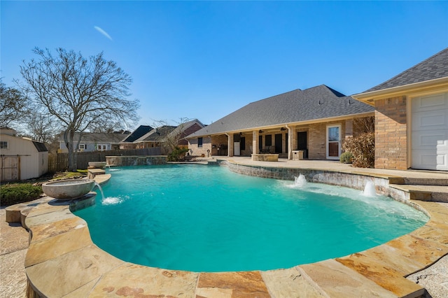 view of swimming pool featuring pool water feature and a patio area