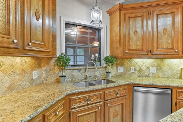 kitchen featuring sink, light stone counters, dishwasher, pendant lighting, and decorative backsplash