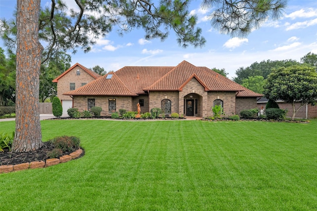 mediterranean / spanish house featuring a front yard