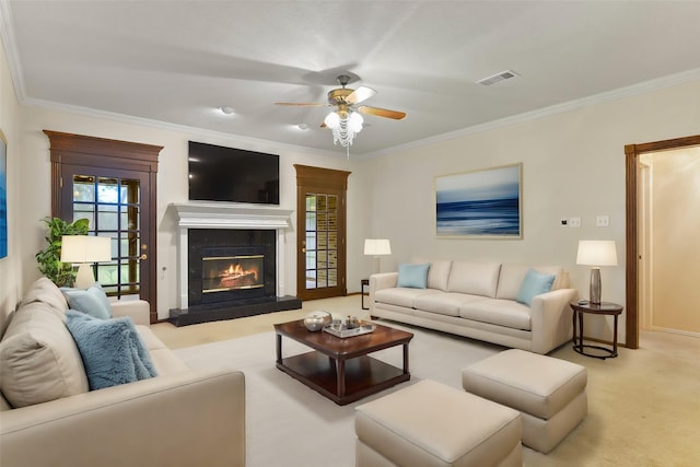 carpeted living room with a fireplace, ornamental molding, and ceiling fan