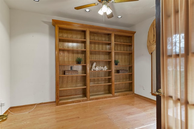 empty room featuring ceiling fan and light hardwood / wood-style floors