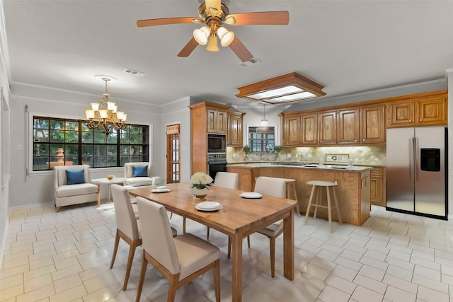 dining room featuring crown molding, a wealth of natural light, and ceiling fan with notable chandelier