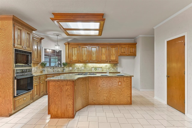 kitchen featuring pendant lighting, sink, a center island, light stone counters, and black appliances