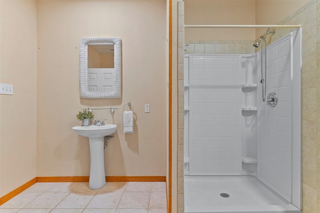 bathroom featuring tile patterned floors and a tile shower