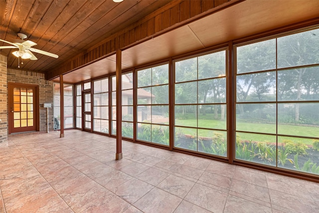 unfurnished sunroom featuring ceiling fan and wooden ceiling