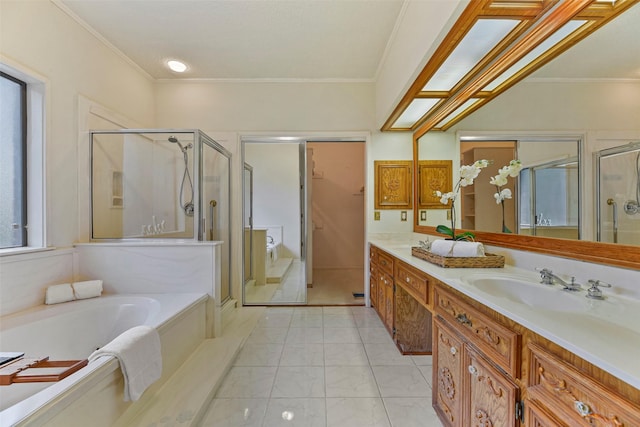 bathroom with ornamental molding, vanity, and shower with separate bathtub