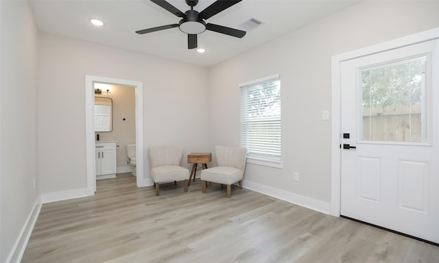 sitting room featuring light hardwood / wood-style floors and ceiling fan