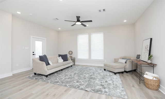 living room with ceiling fan and light wood-type flooring