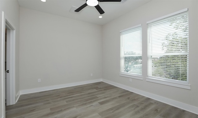 spare room featuring hardwood / wood-style floors, plenty of natural light, and ceiling fan