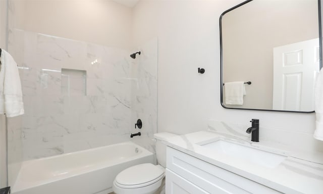 full bathroom with vanity, tiled shower / bath combo, and toilet