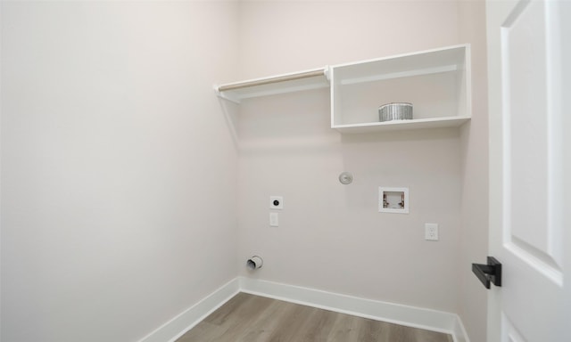 laundry area featuring electric dryer hookup, hookup for a gas dryer, hookup for a washing machine, and light hardwood / wood-style floors