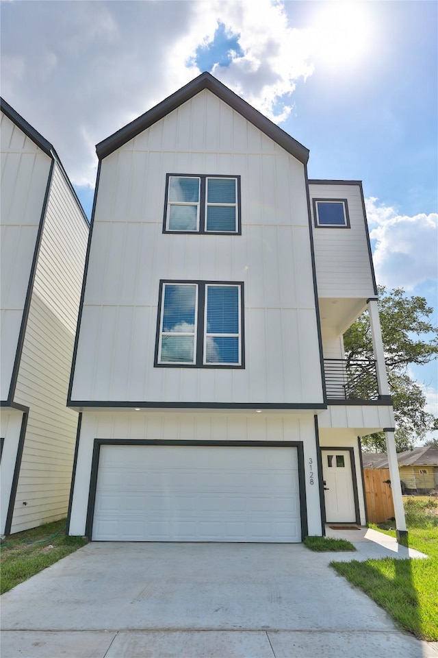 view of front of home with a balcony and a garage