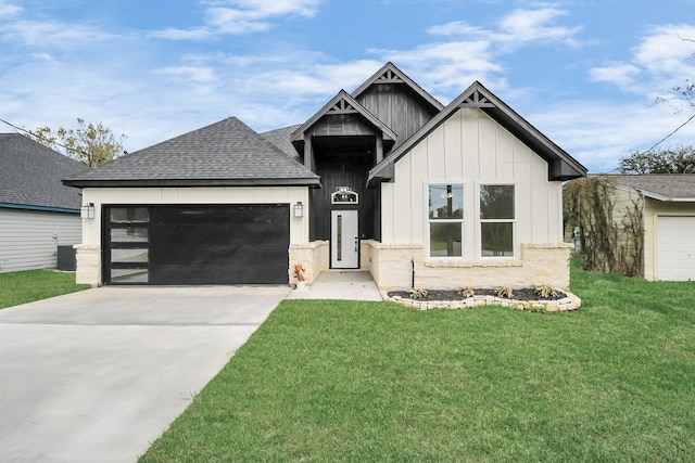 view of front of house featuring a garage, a front lawn, and central air condition unit