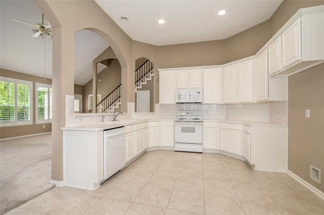 kitchen with ceiling fan, white appliances, backsplash, and white cabinets