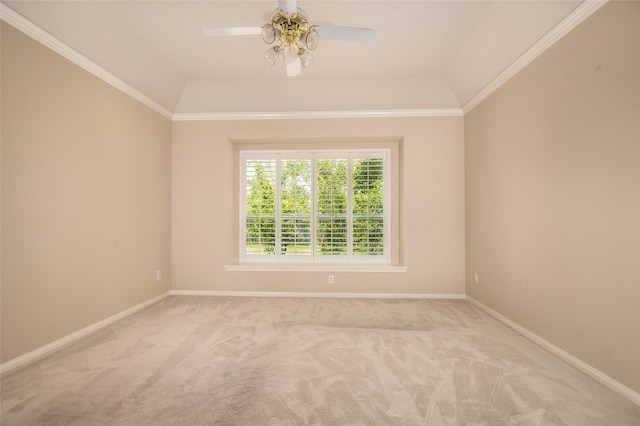 carpeted empty room featuring ceiling fan, ornamental molding, and lofted ceiling