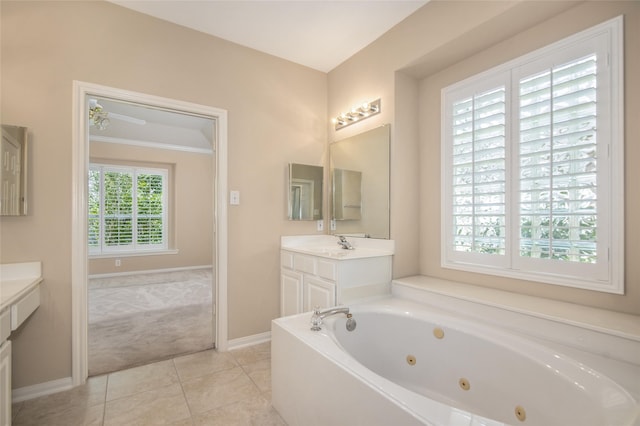 bathroom with vanity, tile patterned flooring, and a washtub