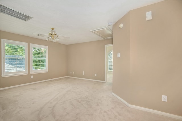 empty room featuring light colored carpet and ceiling fan