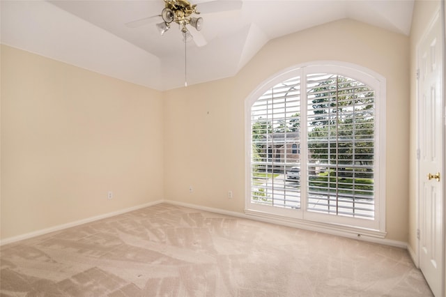 empty room featuring lofted ceiling, light colored carpet, and ceiling fan