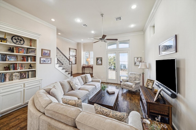 living room featuring ornamental molding, ceiling fan, dark hardwood / wood-style flooring, and french doors