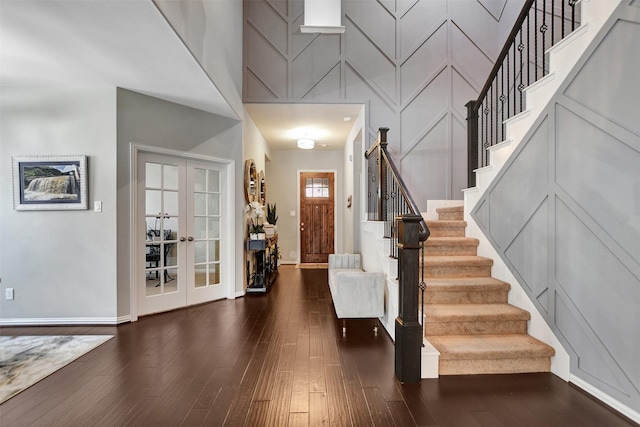 entrance foyer with dark wood-type flooring, french doors, and a high ceiling