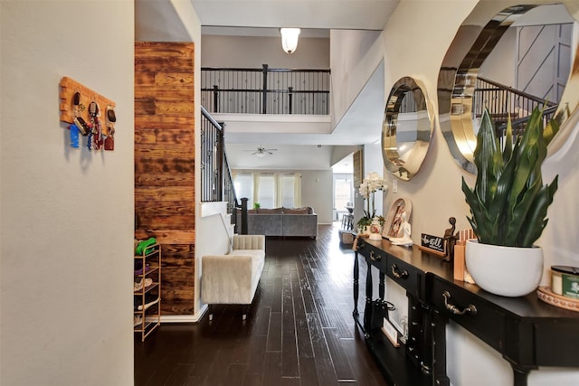 hallway with a high ceiling and dark hardwood / wood-style floors