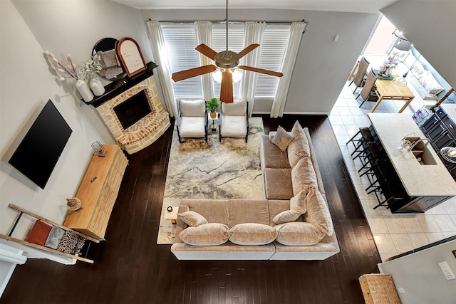 living room featuring wood-type flooring, a healthy amount of sunlight, sink, and ceiling fan