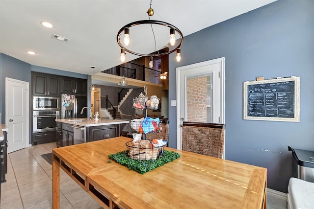 dining area with sink and light tile patterned floors