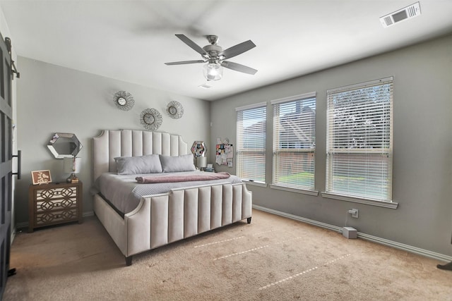 bedroom with light carpet and ceiling fan