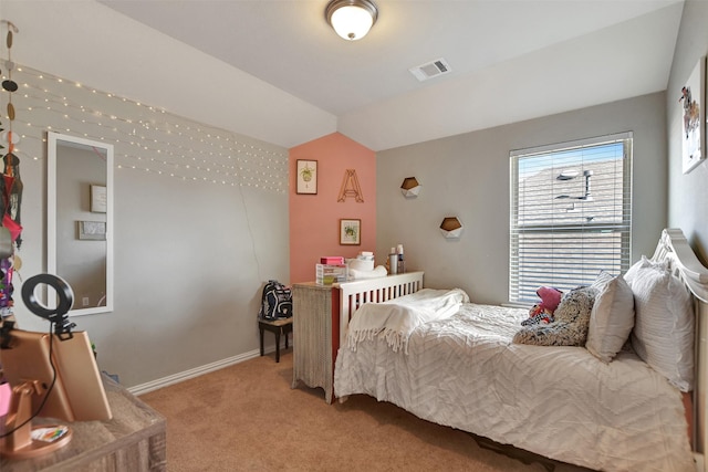 carpeted bedroom with lofted ceiling