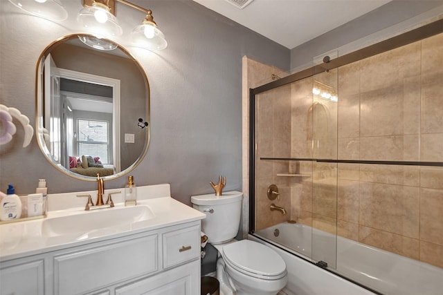 full bathroom with vanity, toilet, and combined bath / shower with glass door