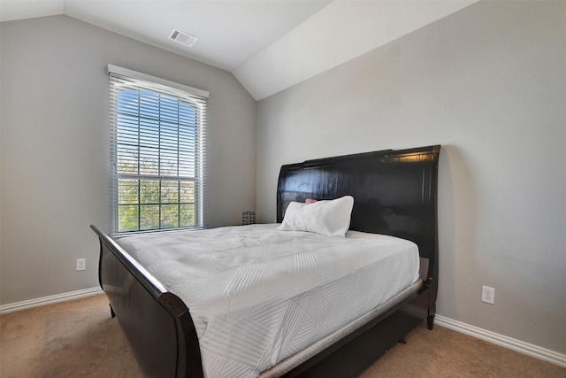 carpeted bedroom featuring lofted ceiling