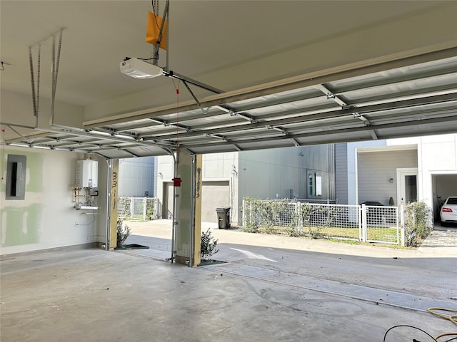 garage with a garage door opener, electric panel, and water heater