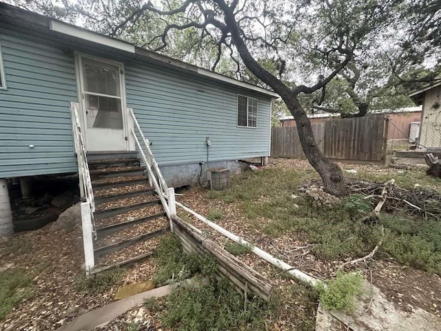 view of side of property featuring central air condition unit