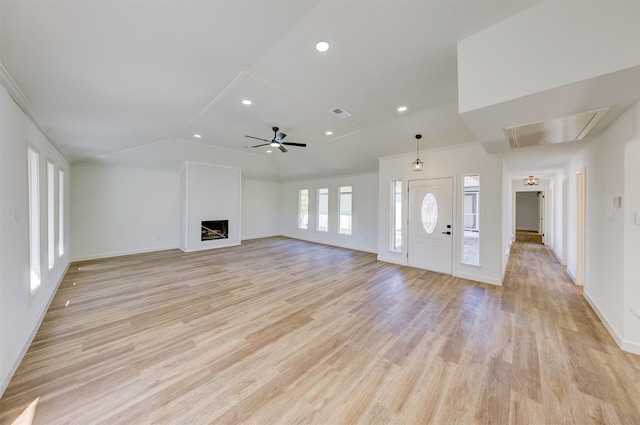 unfurnished living room with ceiling fan, ornamental molding, lofted ceiling, and light wood-type flooring