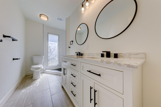 bathroom with tile patterned flooring, vanity, and toilet