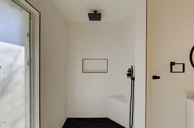 bathroom with a tile shower