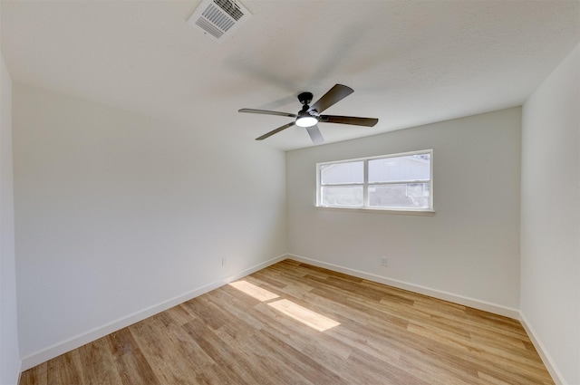 spare room featuring ceiling fan, a textured ceiling, and light wood-type flooring