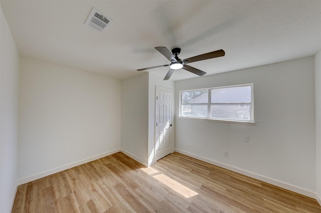 unfurnished room with ceiling fan, a textured ceiling, and light hardwood / wood-style floors