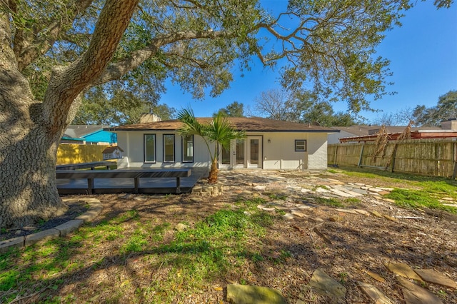 back of property featuring a wooden deck