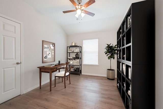 home office featuring hardwood / wood-style flooring, vaulted ceiling, and ceiling fan